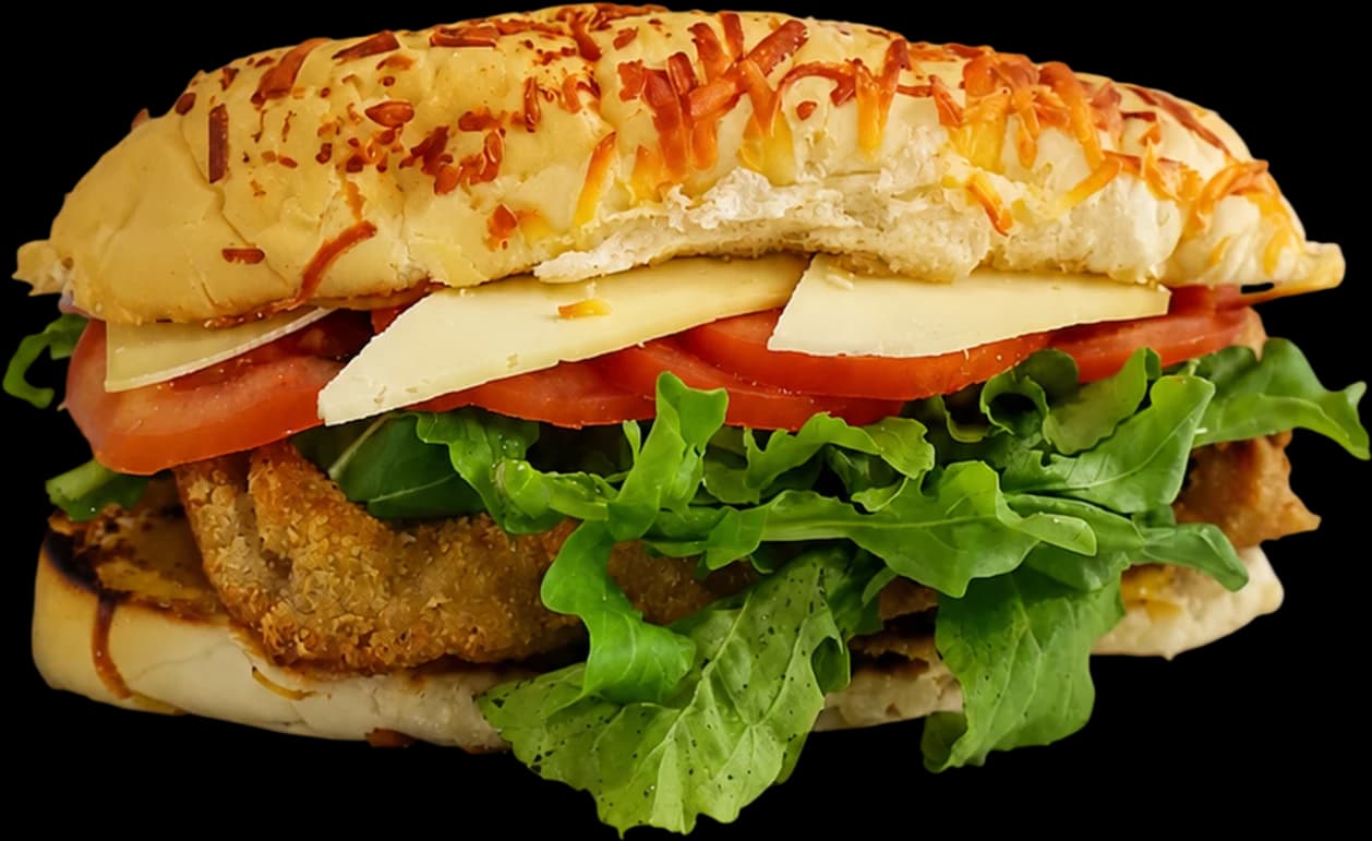 Milandwich de carne recién armado: pan de lomo gratinado, milanesa, queso sardo, rúcula y tomate